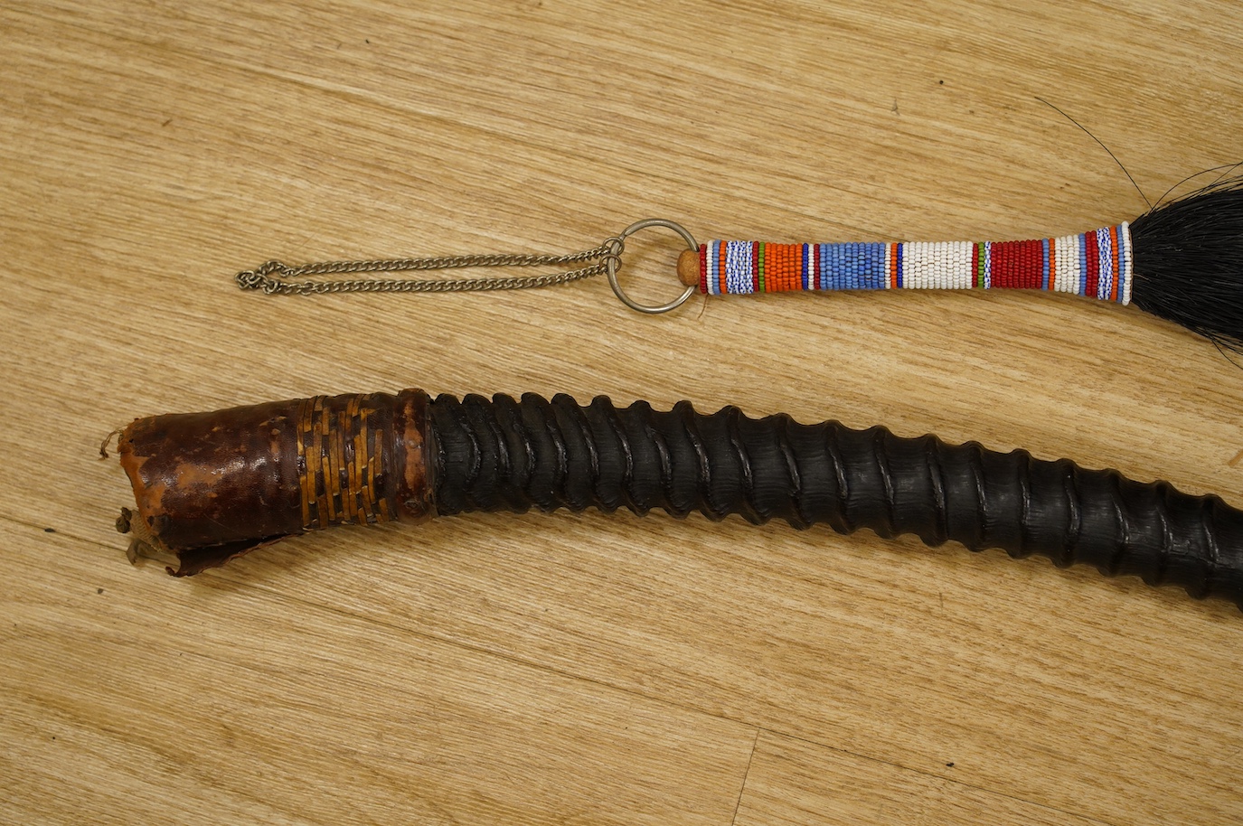 An African antelope horn, 92cm long, and a fly whisk. Condition - fair to good